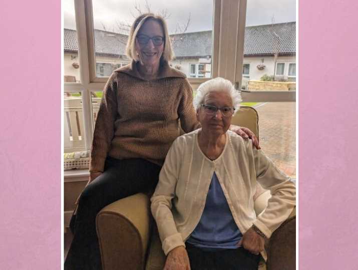 Alyson and Irene sitting in the window of a care home.